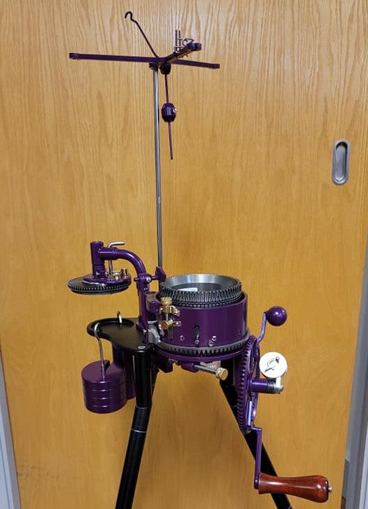 A vintage circular sock machine, showcasing its intricate needle bed and mechanical components